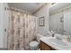 Cozy bathroom featuring floral shower curtain and white single sink vanity with cabinet storage at 391 Hickory Lake Dr, Acworth, GA 30101