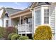 Lovely home with a covered porch and bay windows, surrounded by lush greenery at 391 Hickory Lake Dr, Acworth, GA 30101