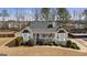 Charming single-story home with a well-maintained lawn, complemented by mature trees and a cozy front porch at 391 Hickory Lake Dr, Acworth, GA 30101