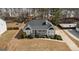 Aerial front view of a home featuring manicured bushes, a covered porch and a driveway at 391 Hickory Lake Dr, Acworth, GA 30101