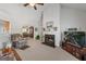 Open concept living room with fireplace, neutral colors, ceiling fan and view into dining and kitchen at 391 Hickory Lake Dr, Acworth, GA 30101