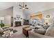 Cozy living room with fireplace, ceiling fan, and large window providing plenty of natural light at 391 Hickory Lake Dr, Acworth, GA 30101