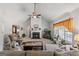 Inviting living room featuring a fireplace, vaulted ceiling, and large windows for natural light at 391 Hickory Lake Dr, Acworth, GA 30101