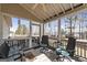 Relaxing screened in porch with ceiling fan, comfortable seating, and an outdoor view at 391 Hickory Lake Dr, Acworth, GA 30101