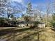 Spacious backyard featuring an expansive lawn and mature trees offering shade and privacy at 2228 Headland Dr, East Point, GA 30344