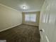 Cozy bedroom featuring neutral walls, carpet flooring, a large window, and baseboard trim at 2228 Headland Dr, East Point, GA 30344