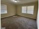Spacious bedroom featuring neutral walls, carpet flooring, and two windows for natural light at 2228 Headland Dr, East Point, GA 30344