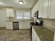 Modern kitchen featuring white cabinets, granite countertops, and stainless steel appliances for a sleek look at 2228 Headland Dr, East Point, GA 30344