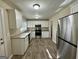 Bright kitchen featuring stainless steel appliances, white cabinetry, granite countertops, and plank flooring at 2228 Headland Dr, East Point, GA 30344