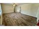 Open living room showcasing hardwood floors, neutral walls, and an open doorway leading to another room at 2228 Headland Dr, East Point, GA 30344