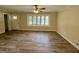 Bright living room featuring beautiful flooring, a ceiling fan, and a large bay window for natural light at 2228 Headland Dr, East Point, GA 30344