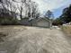 Rear exterior featuring a spacious concrete driveway leading to an attached garage at 2430 Fern Valley Ct, East Point, GA 30344