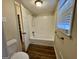 Clean bathroom with white tiled shower and wood floors at 2430 Fern Valley Ct, East Point, GA 30344