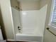 A white tiled bathtub with shower fixture at 2430 Fern Valley Ct, East Point, GA 30344