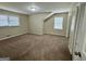Comfortable bedroom featuring two windows, neutral walls, and plush carpeting at 2430 Fern Valley Ct, East Point, GA 30344