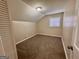 Cozy bedroom featuring neutral walls, brown carpeting, and a window that allows natural light at 2430 Fern Valley Ct, East Point, GA 30344