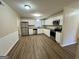 Modern kitchen with white cabinets, stainless steel appliances, and wood floors at 2430 Fern Valley Ct, East Point, GA 30344