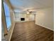 Open living room with a brick fireplace, built in shelving, and wood floors at 2430 Fern Valley Ct, East Point, GA 30344