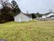 The backyard features a lush lawn, trees, and plenty of space at 890 Old Rocky Rd, Atlanta, GA 30349