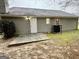 The backyard has a concrete area next to a house with vinyl siding at 890 Old Rocky Rd, Atlanta, GA 30349