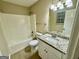 Clean bathroom with granite countertops, updated fixtures, shower-tub, and tile flooring at 890 Old Rocky Rd, Atlanta, GA 30349