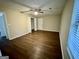 Neutral bedroom with hardwood flooring, ceiling fan, with natural light from a window at 890 Old Rocky Rd, Atlanta, GA 30349