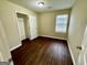 Bedroom with wood floors, closet space, and natural light streaming through the window at 890 Old Rocky Rd, Atlanta, GA 30349