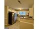 Well-lit kitchen featuring stainless steel appliances, white cabinets, and stone countertops at 890 Old Rocky Rd, Atlanta, GA 30349
