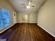 Open-concept living room with hard surface floors and ample space for a variety of furniture arrangements at 890 Old Rocky Rd, Atlanta, GA 30349