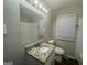 Stylish bathroom featuring a modern vanity with granite countertop and a well-lit mirror at 645 Steve Sw Dr, Atlanta, GA 30315