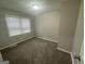 Cozy bedroom featuring neutral paint, plush carpet, and ample natural light at 645 Steve Sw Dr, Atlanta, GA 30315