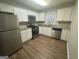 Modern kitchen with stainless steel appliances, granite countertops, and ample cabinet space at 645 Steve Sw Dr, Atlanta, GA 30315