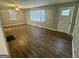 Bright living room with wood-look flooring and natural light streaming through the windows at 645 Steve Sw Dr, Atlanta, GA 30315