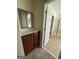 Bathroom area featuring tile floor, mirror, cabinet and doorway to walk-in shower with glass door at 2618 Hooch Ct, Duluth, GA 30097