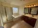 Bright bathroom with double sinks, tub under the window, glass enclosed shower and tile floors at 2618 Hooch Ct, Duluth, GA 30097