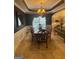 Elegant dining room with wainscoting, chandelier, and a large window with custom draperies at 2618 Hooch Ct, Duluth, GA 30097