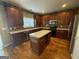 Well-equipped kitchen with an island, granite countertops, and dark wood cabinetry at 2618 Hooch Ct, Duluth, GA 30097