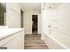 Bright bathroom with a bathtub and shower combination and modern vanity at 415 Arthurs Ln, Covington, GA 30016