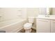 Bright bathroom featuring a tub and shower combination, toilet, and single sink vanity at 415 Arthurs Ln, Covington, GA 30016