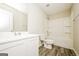 Bright bathroom featuring a tub and shower combination, toilet, and single sink vanity at 415 Arthurs Ln, Covington, GA 30016