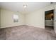 Spacious carpeted bedroom with natural light, perfect for relaxation and comfort at 415 Arthurs Ln, Covington, GA 30016