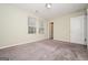 View of the spacious bedroom with neutral carpeting and two windows letting in natural light at 415 Arthurs Ln, Covington, GA 30016