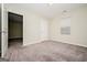 View of the spacious bedroom with neutral carpeting and a window letting in natural light at 415 Arthurs Ln, Covington, GA 30016