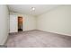 Large carpeted bedroom with a walk-in closet and view into the en-suite bathroom at 415 Arthurs Ln, Covington, GA 30016