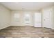Bright dining room with wood-look floors, white trim, and a sliding glass door to the backyard at 415 Arthurs Ln, Covington, GA 30016