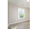 Neutrally painted bedroom featuring a window and light wood-look flooring at 430 Birch Se Ln, Conyers, GA 30094