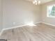 Well-lit bedroom featuring modern flooring and neutral wall paint at 430 Birch Se Ln, Conyers, GA 30094