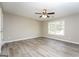 Large bedroom with wood-look laminate flooring, ceiling fan, and natural light at 430 Birch Se Ln, Conyers, GA 30094