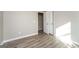 Bright bedroom with an open closet featuring light wood-look flooring at 430 Birch Se Ln, Conyers, GA 30094