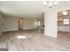 Open-concept living space with laminate flooring and a view into the kitchen at 430 Birch Se Ln, Conyers, GA 30094